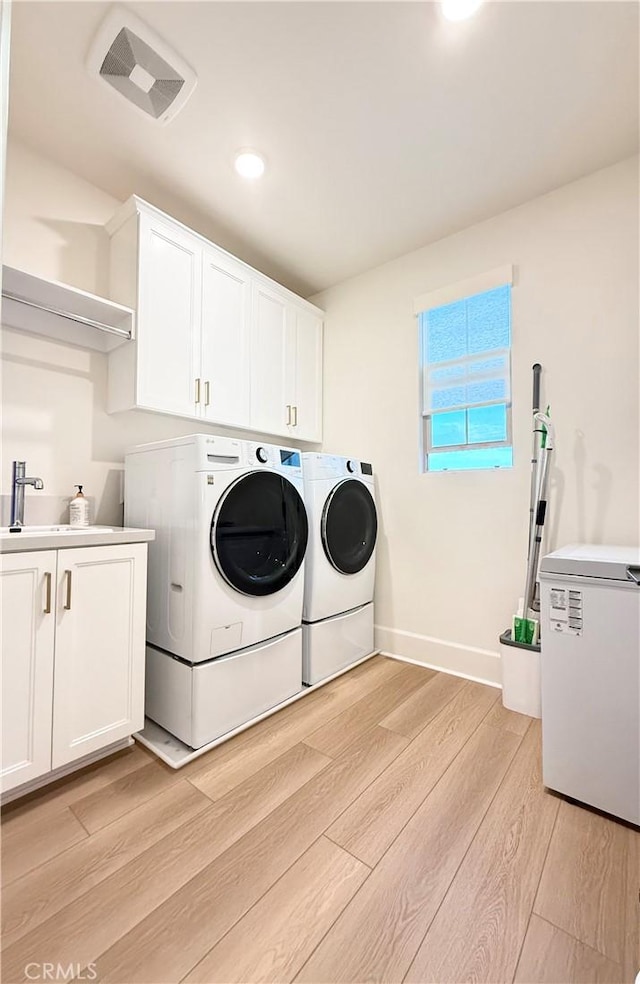 8896 Los Coyotes Ct Unit 410, Buena Park, CA 90621 - laundry room with independent washer and dryer, cabinet space, light wood-style flooring, recessed lighting, and baseboards