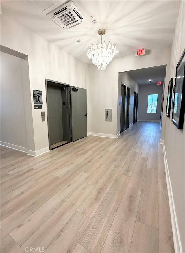 8896 Los Coyotes Ct Unit 410, Buena Park, CA 90621 - hall with light wood-type flooring, baseboards, and a chandelier