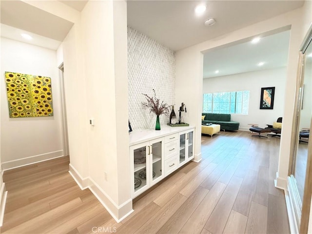 8896 Los Coyotes Ct Unit 410, Buena Park, CA 90621 - hallway with light wood finished floors, baseboards, recessed lighting, and an accent wall
