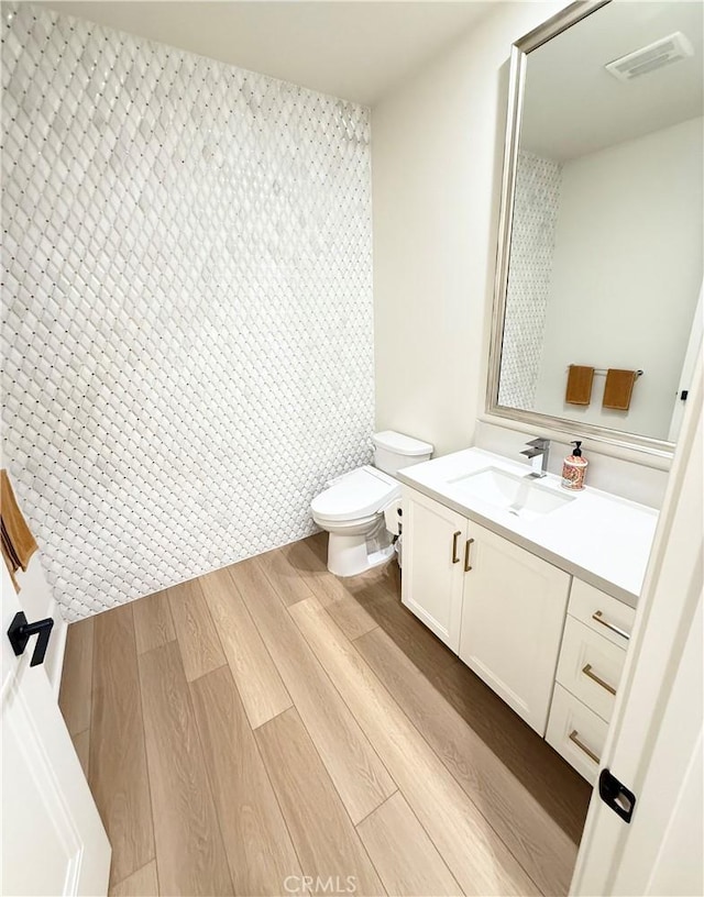 8896 Los Coyotes Ct Unit 410, Buena Park, CA 90621 - bathroom featuring vanity, wood finished floors, and toilet