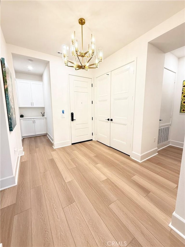 8896 Los Coyotes Ct Unit 410, Buena Park, CA 90621 - entryway featuring a chandelier, light wood-type flooring, and baseboards