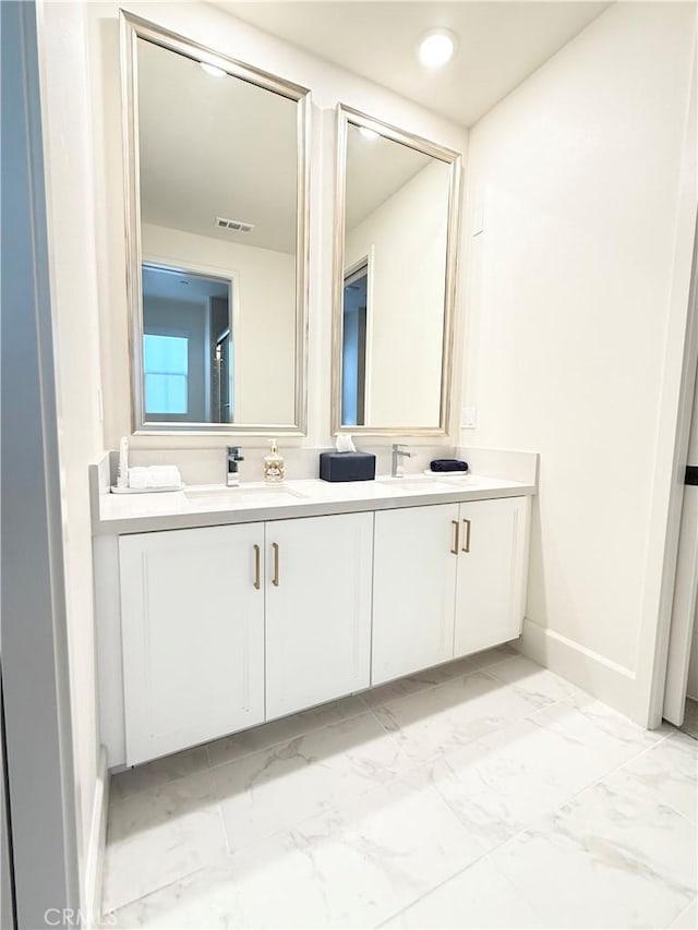 8896 Los Coyotes Ct Unit 410, Buena Park, CA 90621 - bathroom featuring double vanity, marble finish floors, and baseboards
