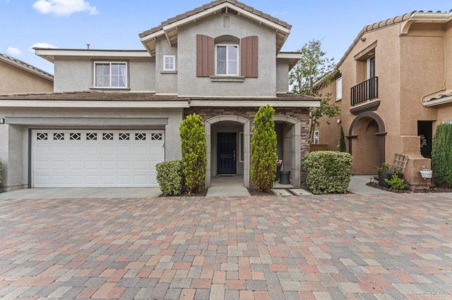 9925 Fieldthorn St, San Diego, CA 92127 - view of front of home featuring stucco siding, decorative driveway, and a balcony