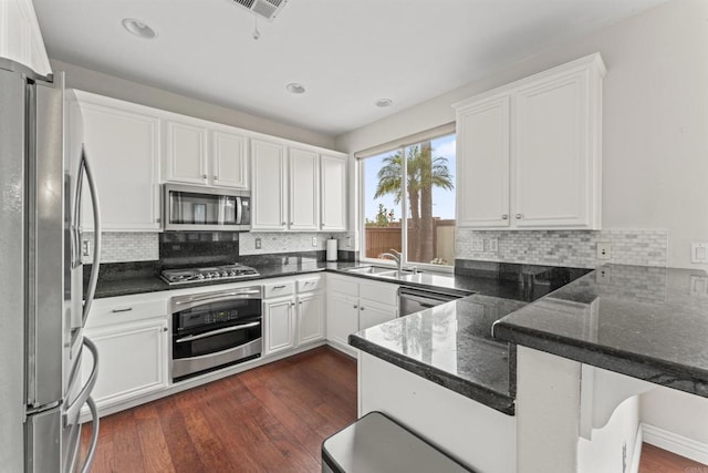 9925 Fieldthorn St, San Diego, CA 92127 - kitchen featuring stainless steel appliances, a peninsula, white cabinets, decorative backsplash, and recessed lighting