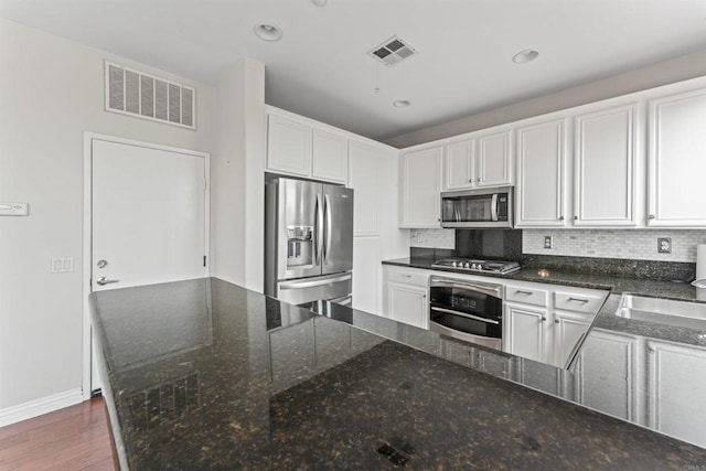 9925 Fieldthorn St, San Diego, CA 92127 - kitchen featuring stainless steel appliances, white cabinets, tasteful backsplash, dark stone counters, and recessed lighting