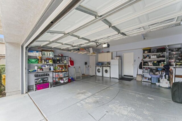 9925 Fieldthorn St, San Diego, CA 92127 - garage featuring washer and dryer, freestanding refrigerator, a garage door opener, and water heater