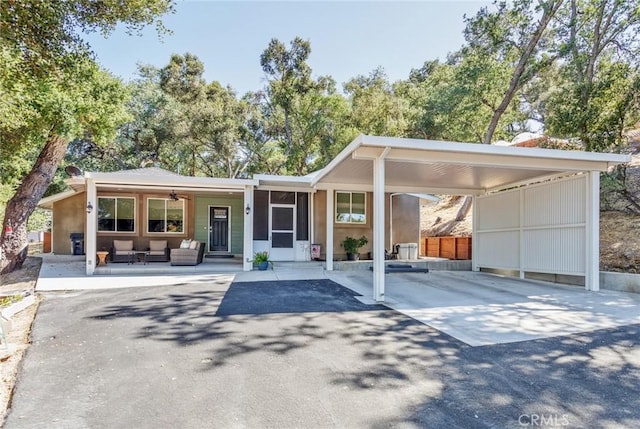 8390 Curbaril Ave, Atascadero, CA 93422 - view of front facade with an outdoor hangout area, an attached carport, driveway, and a ceiling fan