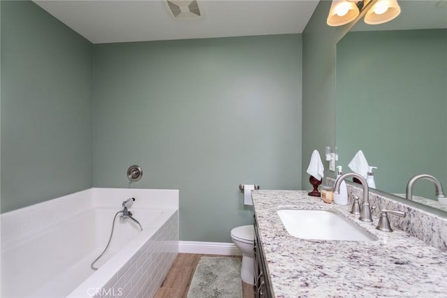 8390 Curbaril Ave, Atascadero, CA 93422 - bathroom featuring vanity, a garden tub, toilet, baseboards, and wood finished floors