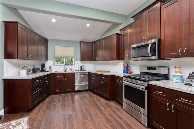8390 Curbaril Ave, Atascadero, CA 93422 - kitchen featuring stainless steel appliances, vaulted ceiling, a sink, dark wood-style floors, and backsplash