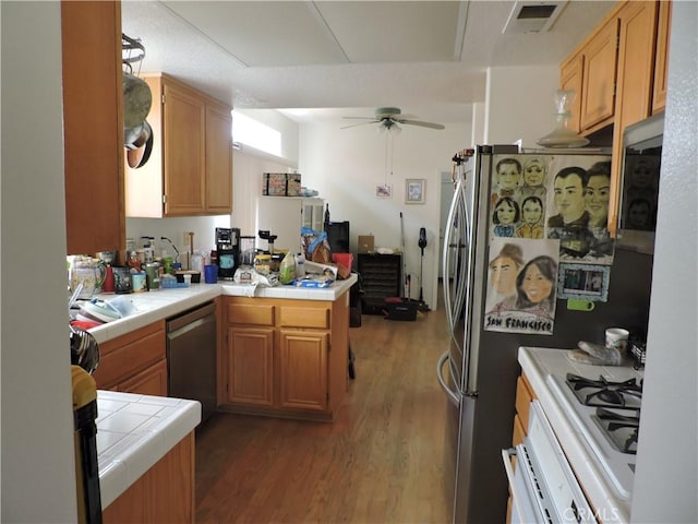 19598 Rolling Green Dr, Apple Valley, CA 92308 - kitchen with tile countertops, dishwasher, wood finished floors, and a peninsula