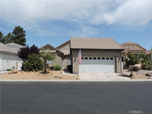 19598 Rolling Green Dr, Apple Valley, CA 92308 - view of front of home featuring an attached garage, a tiled roof, stucco siding, and concrete driveway