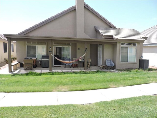 19598 Rolling Green Dr, Apple Valley, CA 92308 - back of property with a patio, stucco siding, and a yard