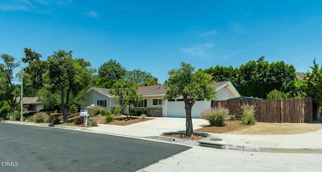10503 Jimenez St, Sylmar, CA 91342 - ranch-style home featuring a garage, concrete driveway, and stone siding