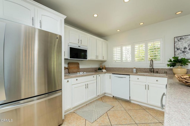 10503 Jimenez St, Sylmar, CA 91342 - kitchen with white appliances, a sink, white cabinetry, recessed lighting, and light countertops