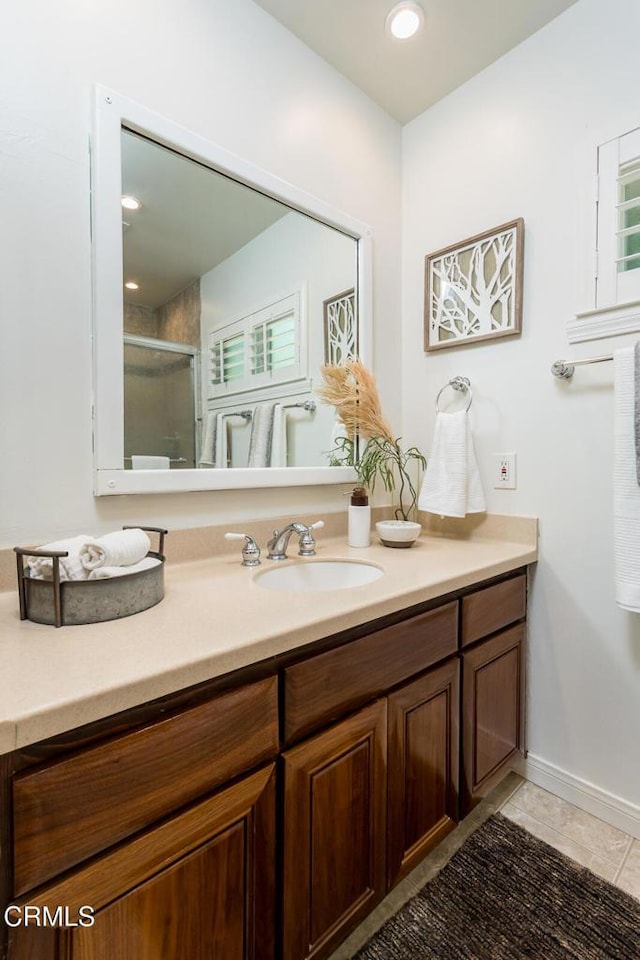 10503 Jimenez St, Sylmar, CA 91342 - full bath with vanity, an enclosed shower, tile patterned floors, recessed lighting, and baseboards