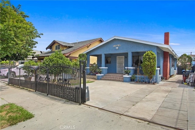 916 W 53rd St, Los Angeles, CA 90037 - bungalow with a porch, a fenced front yard, a chimney, and stucco siding