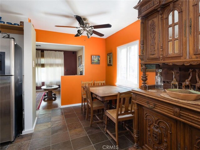 5526 W 118th Pl, Hawthorne, CA 90304 - dining space featuring ceiling fan, plenty of natural light, baseboards, and dark stone finish flooring