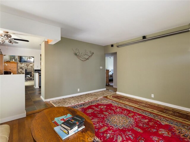 5526 W 118th Pl, Hawthorne, CA 90304 - living room featuring ceiling fan, baseboards, and a stone fireplace