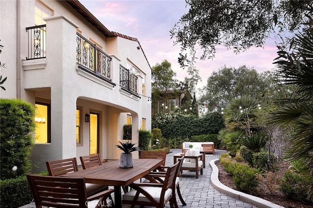 47 Via Alcamo, San Clemente, CA 92673 - patio terrace at dusk with a balcony, a patio, outdoor dining area, and an outdoor hangout area