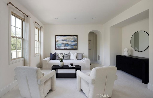 47 Via Alcamo, San Clemente, CA 92673 - living room with arched walkways, light carpet, and baseboards