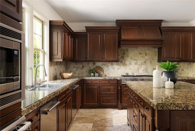 47 Via Alcamo, San Clemente, CA 92673 - kitchen with a sink, premium range hood, appliances with stainless steel finishes, tasteful backsplash, and light stone countertops