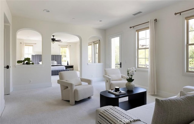 47 Via Alcamo, San Clemente, CA 92673 - carpeted living room featuring arched walkways, healthy amount of natural light, baseboards, and ceiling fan