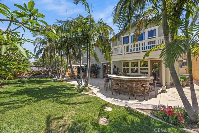4267 Carnegie Ct, Riverside, CA 92505 - back of house with stucco siding, a lawn, a patio, and a balcony
