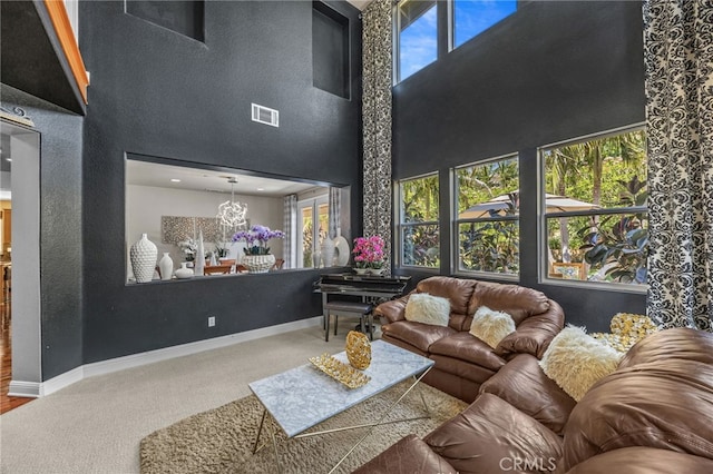 4267 Carnegie Ct, Riverside, CA 92505 - carpeted living room with a towering ceiling, healthy amount of natural light, and a chandelier