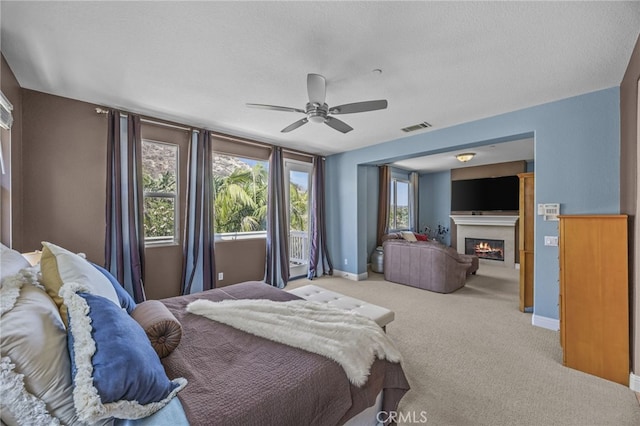 4267 Carnegie Ct, Riverside, CA 92505 - bedroom with a glass covered fireplace, carpet floors, a ceiling fan, and a textured ceiling