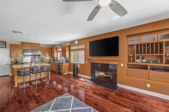 4267 Carnegie Ct, Riverside, CA 92505 - living room featuring dark wood-type flooring, ceiling fan, and a fireplace