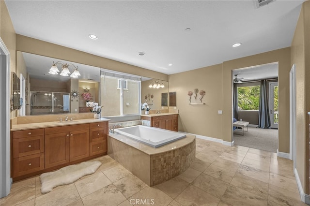 4267 Carnegie Ct, Riverside, CA 92505 - bathroom with a stall shower, a garden tub, two vanities, recessed lighting, and tile patterned floors