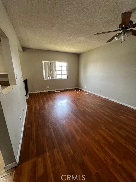 13753 Los Angeles St, Baldwin Park, CA 91706 - unfurnished living room featuring wood finished floors, baseboards, a textured ceiling, and a ceiling fan