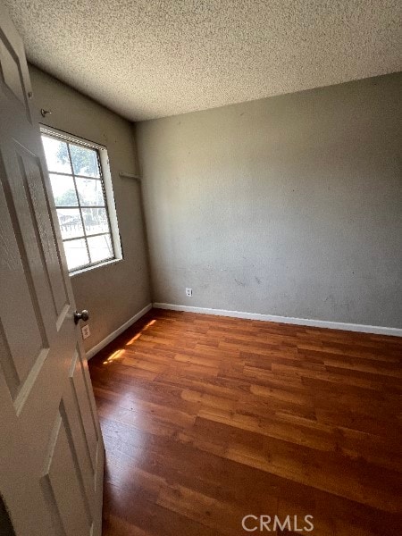 13753 Los Angeles St, Baldwin Park, CA 91706 - unfurnished room with wood finished floors, a textured ceiling, and baseboards