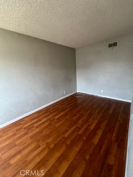 13753 Los Angeles St, Baldwin Park, CA 91706 - spare room featuring wood finished floors, baseboards, and a textured ceiling