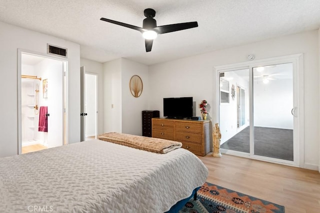 609 S Palm Ave Unit B, Hemet, CA 92543 - bedroom with light wood-style floors, a textured ceiling, a ceiling fan, connected bathroom, and baseboards