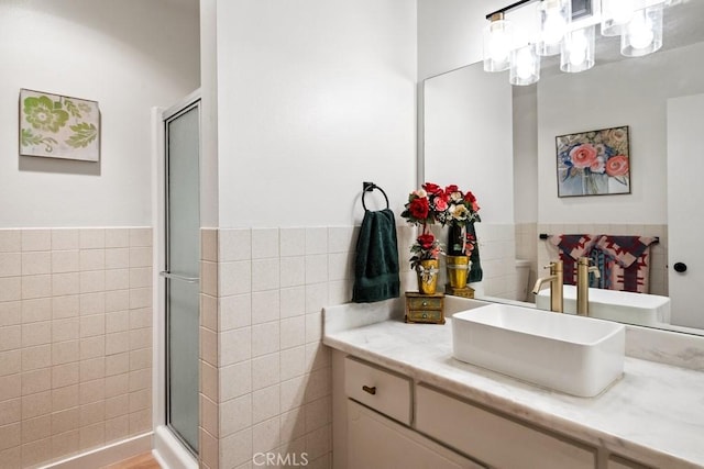 609 S Palm Ave Unit B, Hemet, CA 92543 - full bathroom featuring tile walls, vanity, a stall shower, a chandelier, and wainscoting