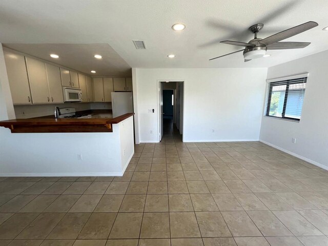 2556 Ocean Cove Dr, Cardiff By The Sea, CA 92007 - kitchen featuring white microwave, range, a ceiling fan, a peninsula, and recessed lighting