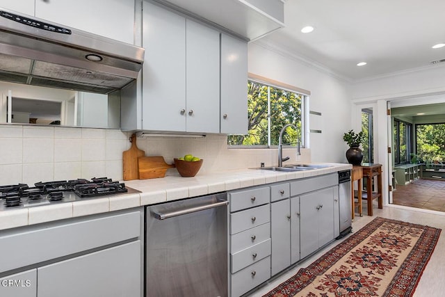1245 S Orange Grove Blvd Unit 5, Pasadena, CA 91105 - kitchen with ventilation hood, stainless steel appliances, tile countertops, ornamental molding, and tasteful backsplash