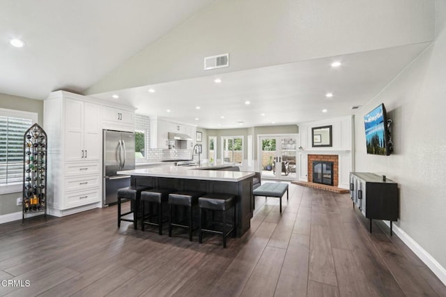 5406 Luis Dr, Agoura Hills, CA 91301 - kitchen featuring stainless steel fridge, dark wood-style floors, white cabinetry, a large island with sink, and recessed lighting