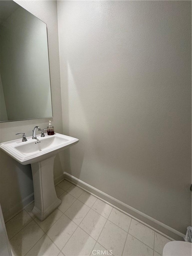 3641 E Moonlight St Unit 51, Ontario, CA 91761 - bathroom with baseboards, toilet, and tile patterned flooring