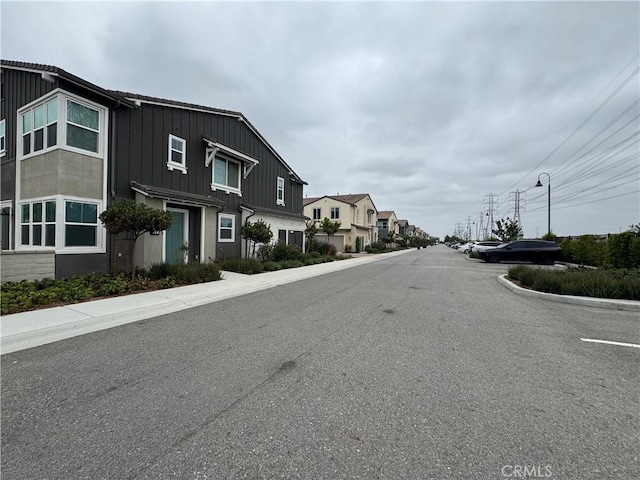 3641 E Moonlight St Unit 51, Ontario, CA 91761 - view of asphalt street with a residential view, sidewalks, and curbs