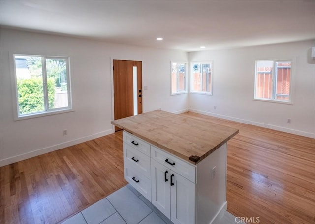 1522 N Benton Way, Los Angeles, CA 90026 - kitchen with white cabinetry, light wood-type flooring, baseboards, a kitchen island, and recessed lighting