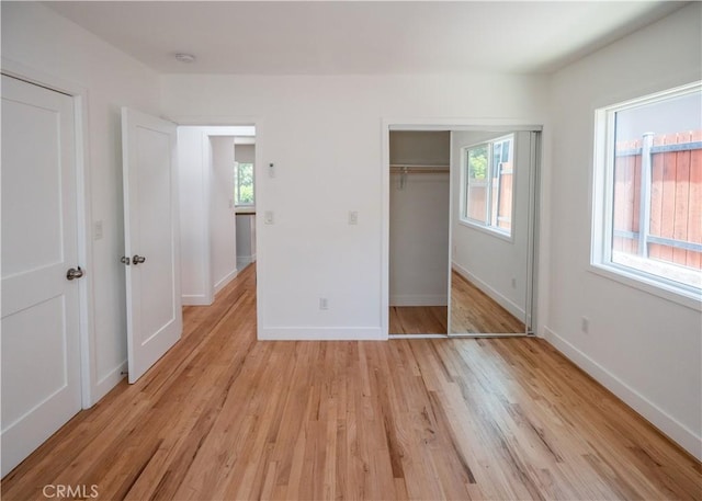 1522 N Benton Way, Los Angeles, CA 90026 - unfurnished bedroom with light wood-style flooring, a closet, and baseboards
