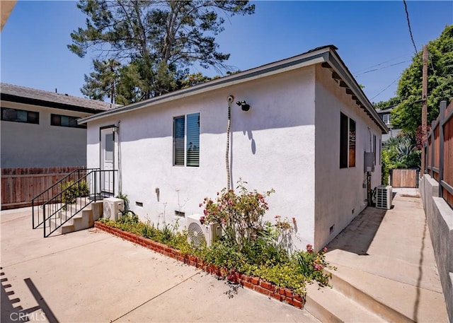 1522 N Benton Way, Los Angeles, CA 90026 - view of property exterior with crawl space, a patio area, stucco siding, and a cooling unit