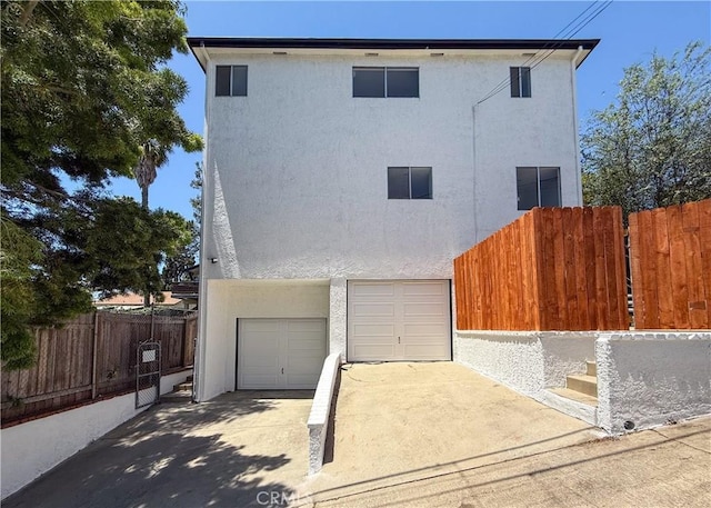 1522 N Benton Way, Los Angeles, CA 90026 - view of front of home with stucco siding, a garage, and driveway