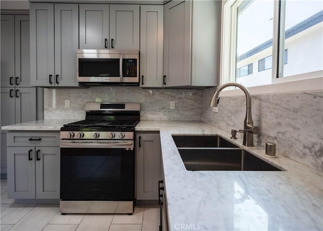 1522 N Benton Way, Los Angeles, CA 90026 - kitchen featuring stainless steel appliances, a sink, and gray cabinetry