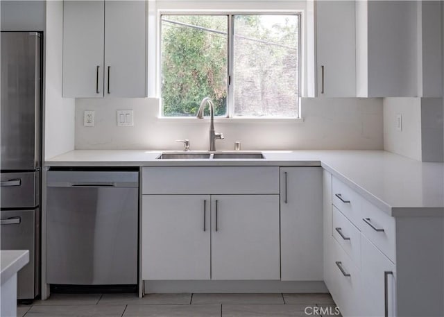 1522 N Benton Way, Los Angeles, CA 90026 - kitchen with stainless steel appliances, a sink, white cabinetry, backsplash, and light countertops