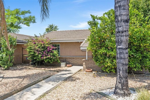 2820 W Devonshire Ave, Hemet, CA 92545 - obstructed view of property with stucco siding and a tile roof