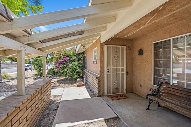 2820 W Devonshire Ave, Hemet, CA 92545 - doorway to property with stucco siding and a patio area