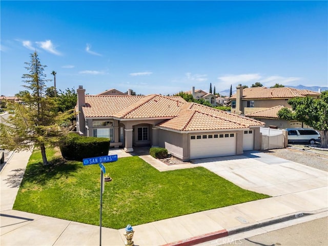13073 San Dimas Cir, Victorville, CA 92392 - mediterranean / spanish-style home with a garage, stucco siding, a tiled roof, a chimney, and concrete driveway